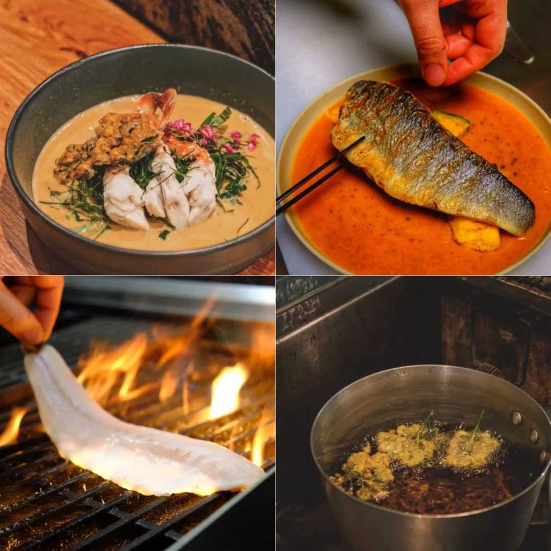 黑筷夹起焦纹烤鱼浸入橘红酱汁，南瓜块与香叶浮于表层。釉裂深盘衬金黄鱼皮，自制辣椒酱折射"非预制品"理念。背景模糊霓虹"EAT SEAFOOD THAI"呼应品牌，佐证文中"自调酱料"核心工艺。